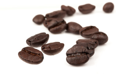 Closeup of coffee beans with focus on one