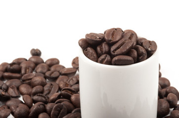 Closeup of coffee beans with focus on one