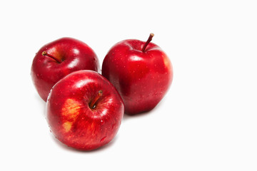 three red organic apples