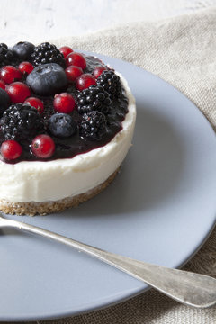 mini cheesecake with red fruits on plate with fork