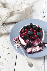 eaten mini cheesecake with red fruits on plate