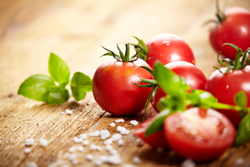 Tomatoes lying on old table. Diet food