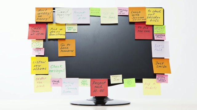 Time lapse of monitor with post-it notes on white background