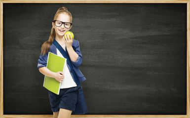 Schoolgirl with book apple and blackboard, school girl child