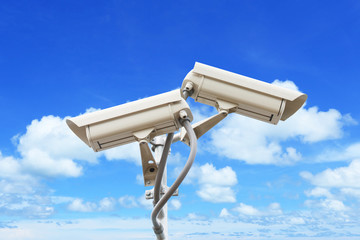 Security camera on blue sky background