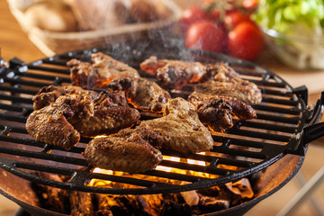 Grilling chicken wings on barbecue grill