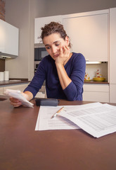 Unemployed and divorced woman with debts reviewing her monthly