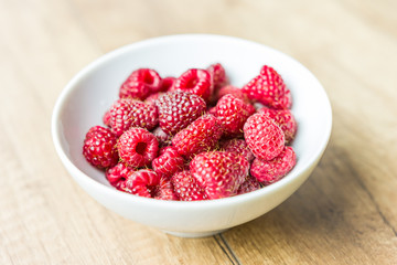 Fresh Raspberry Fruits In White Bowl