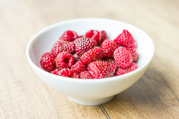 Fresh Raspberry Fruits In White Bowl