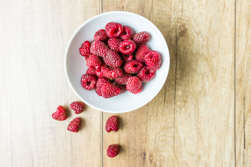 Fresh Raspberry Fruits In White Bowl