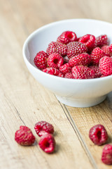 Fresh Raspberry Fruits In White Bowl