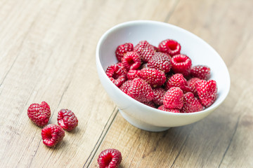 Fresh Raspberry Fruits In White Bowl