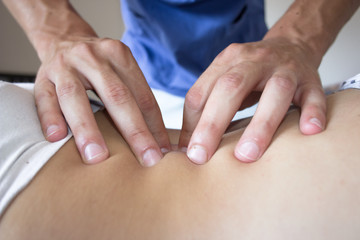 osteopath hands on patient back - obrazy, fototapety, plakaty