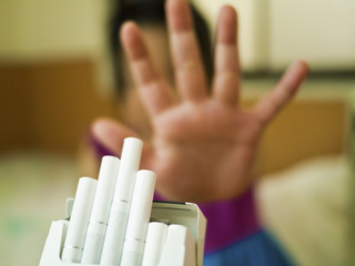 refusing cigarettes with a hand sign