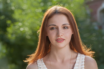 Cute redhead  women front view looking at camera.