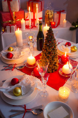 Christmas dishware on the white and red table