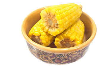 Boiled corn in ceramic bowl isolated on white