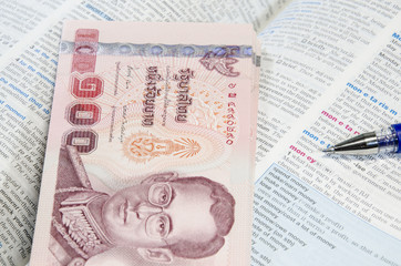 Thai banknote and dictionary