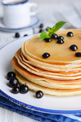 Sweet pancakes with berries on table close-up