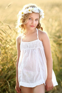 portrait of a beautiful little girl in a field