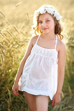 portrait of a beautiful little girl in a field