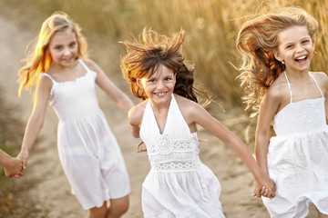 portrait of little girls running on the field