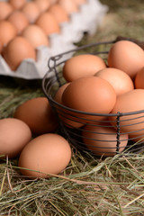 Eggs in wicker basket on table close-up