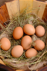 Eggs in wooden basket on table close-up