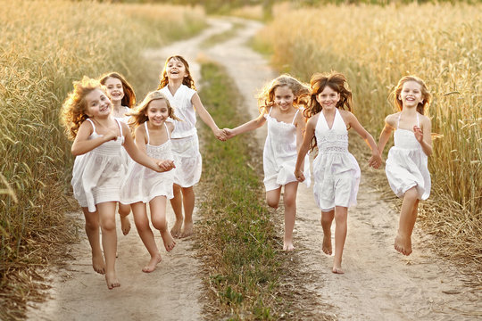 portrait of little girls running on the field