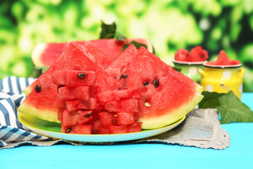 Fresh slices of watermelon on table, outdoors