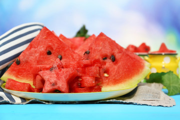 Fresh slices of watermelon on table, on bright background