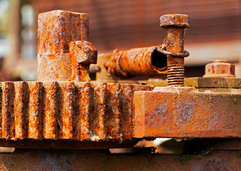 Old and rusty pinion gear of a machine in factory