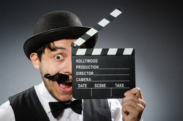 Funny man with movie clapper board