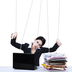 Businesswoman working like marionette