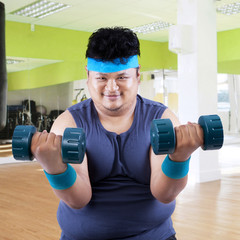 Fat man exercise in fitness center 3