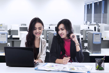 Two young businesswomen in office