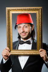 Man with fez  hat and picture frame