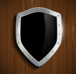 metal shield on a wooden surface