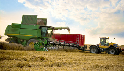 A grain combine with trailer.