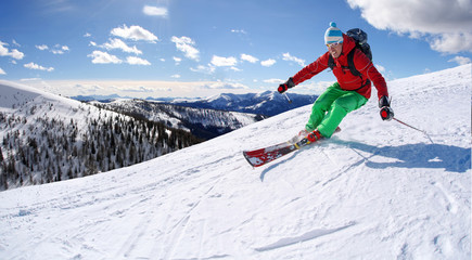 Naklejka na ściany i meble Skier against blue sky in high mountains