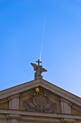 Angel with cross against falling airplane