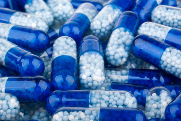 Blue capsules (pills) background - 68624135