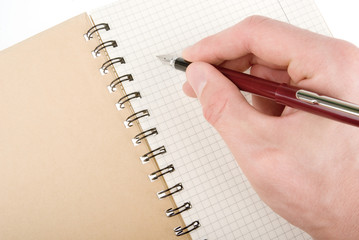 Hand writing on empty notepad (notebook) isolated on white