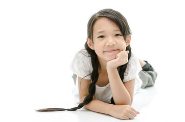 Little cute asian girl resting chin by hand