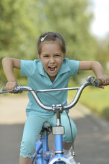 Fototapeta na wymiar Happy girl on a bicycle
