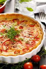 Tart with tomatoes, cheese and herbs