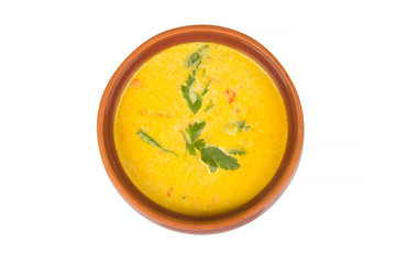 cheese soup in a brown bowl