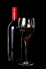 A glass and a bottle of red wine