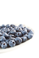 plate with blueberries isolated on white background