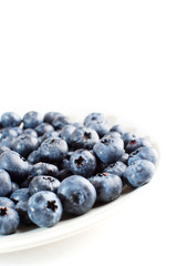 plate with blueberries isolated on white background